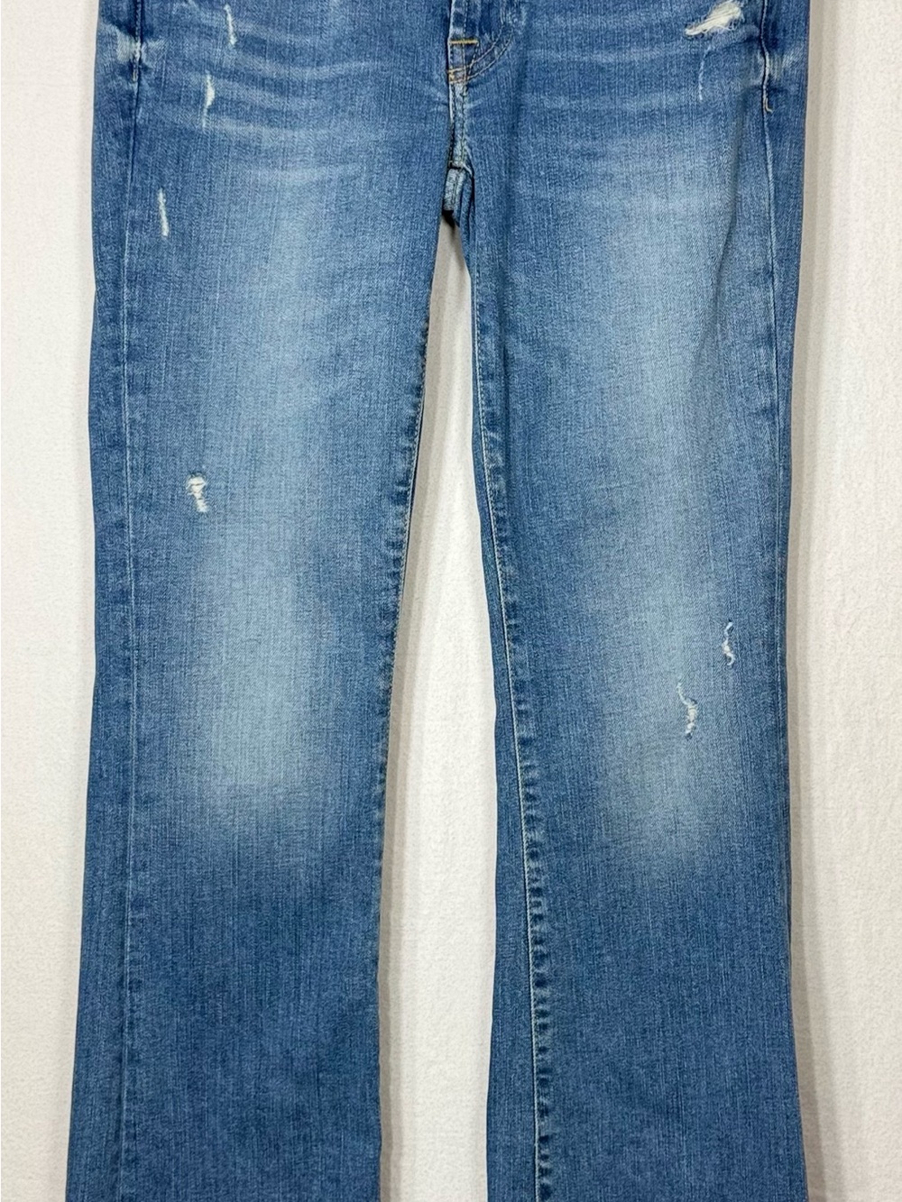 7 For All Mankind Light Blue Bootcut Jeans with Distressed Detailing